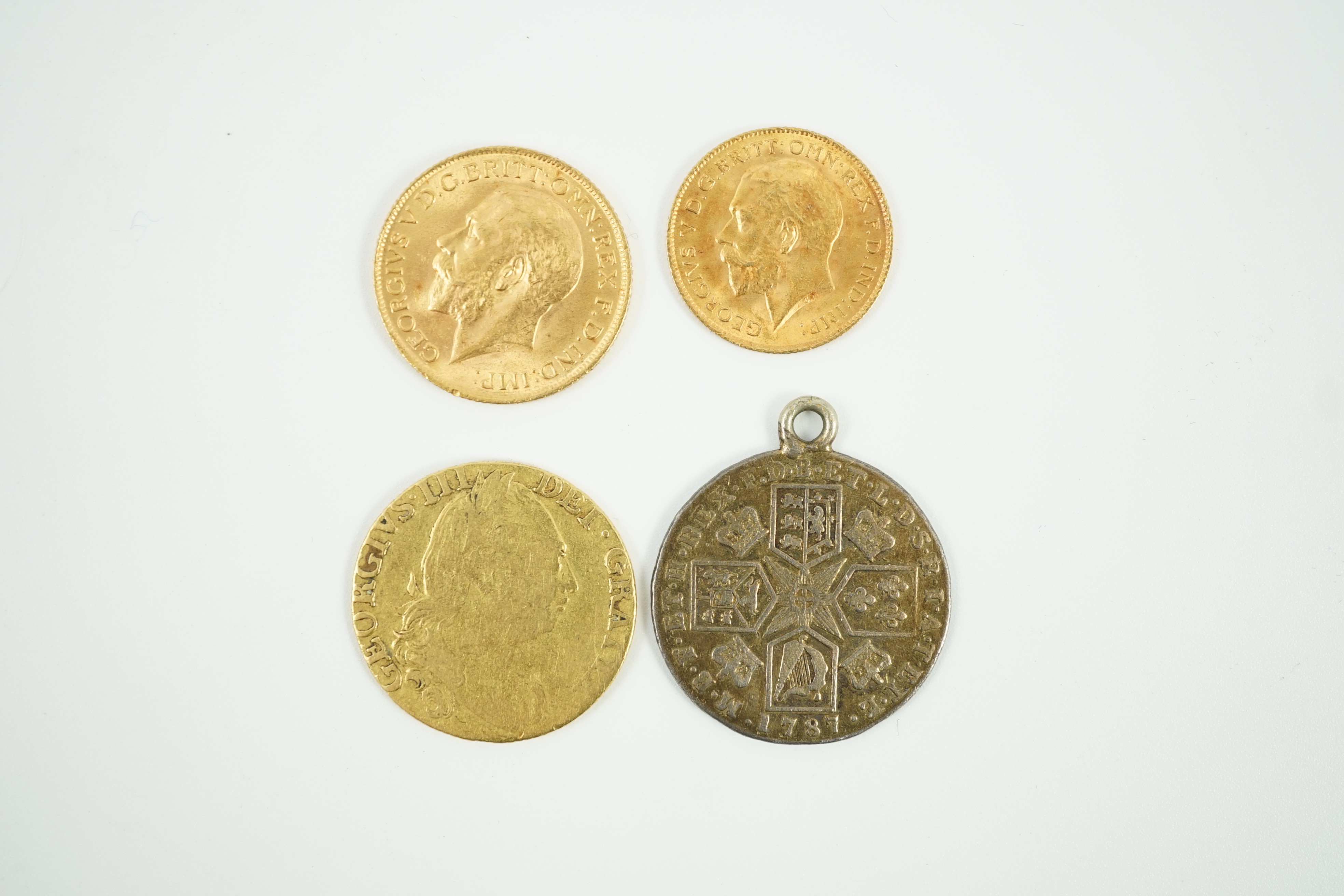 A George V 1915 gold sovereign and a 1915 gold half sovereign, a George III 1782 gold guinea(worn) and a George III 1787 shilling, with pendant mount.